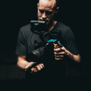 A cinematographer adjusts a camera rig with precision, ready for the next scene.