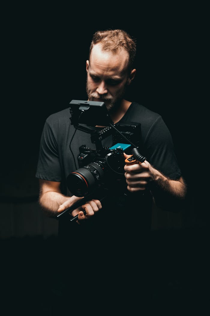 A cinematographer adjusts a camera rig with precision, ready for the next scene.